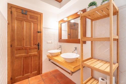 a bathroom with a sink and a mirror at Cueva Del Gollisno in Chulilla
