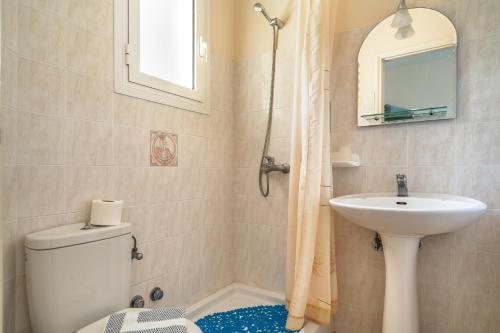 a bathroom with a toilet and a sink at Anemona studio D in Kefallonia