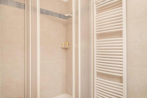 a bathroom with a shower with white walls at Vorderschöneck 2 in Longostagno