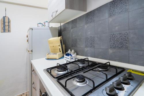 a kitchen with a stove and a refrigerator at Villetta Granelli in Granelli