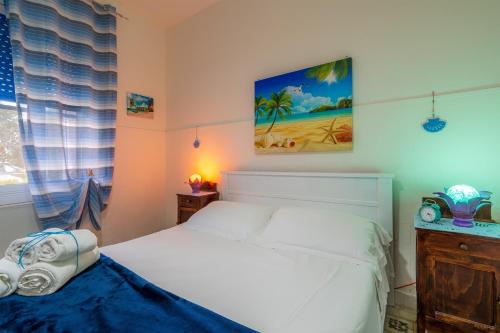 a bedroom with a white bed and a window at Villetta Granelli in Granelli