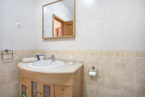 a bathroom with a sink and a mirror at A O - Ferrel House Casual in Ferrel