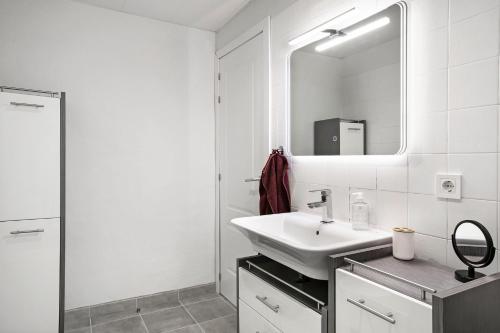 a white bathroom with a sink and a mirror at Fewo Arafo in Güimar