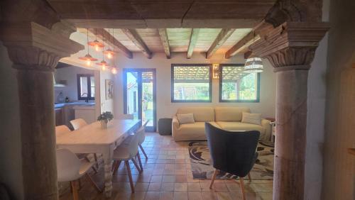 a living room with a table and a couch at Son Del Rio Nou in Pollença
