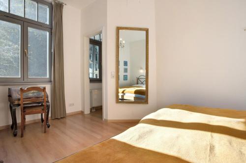 a bedroom with a bed and a mirror at Effi-Briest-Villa in Heringsdorf