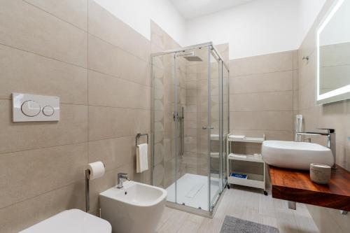 a bathroom with a shower and a toilet and a sink at Le scuderie 10 in Galatone