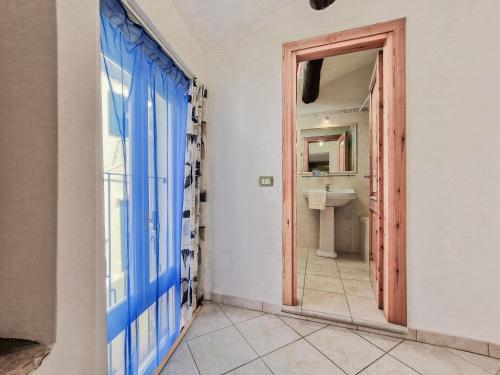 a bathroom with a blue door and a sink at Il Borgo 4 in Capoliveri