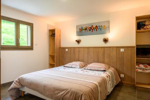 a bedroom with a large bed in a room at Chalet du Piedmont in Cornimont