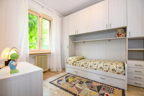 a bedroom with a bed and a desk and a window at Casa Doss in Tremosine Sul Garda