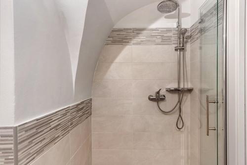 a bathroom with a shower with a glass door at Logge dei Paroloti Paolo in San Lorenzo in Banale