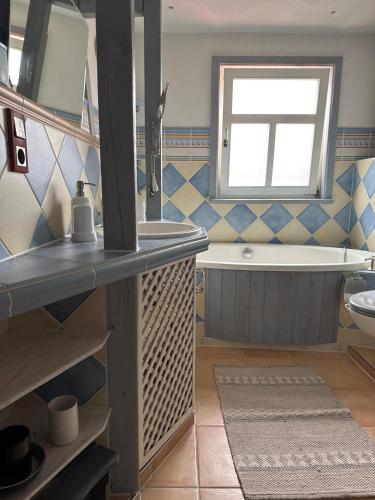 a bathroom with a tub and a sink and a bath tub at Thüringer Landidyll in Bösleben-Wüllersleben
