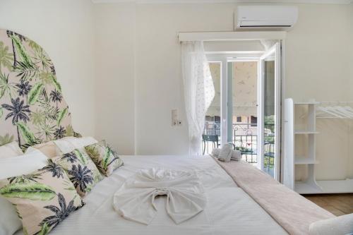 a bedroom with a white bed with a bow on it at M3 room in Nikiana