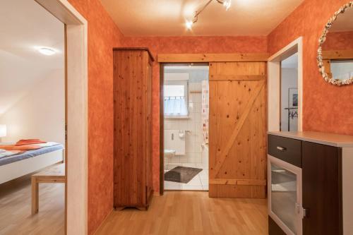 a bathroom with a sliding barn door in a bedroom at Ferienwohnung Tasoli in Lindau