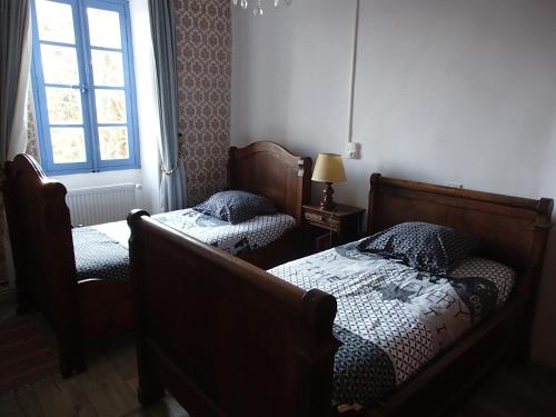 a bedroom with two beds and a window at Appartement Authentique Montaigut in Gissac