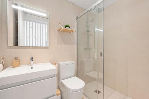 a bathroom with a toilet and a sink and a shower at Horus Beach Paradise in Torre del Mar