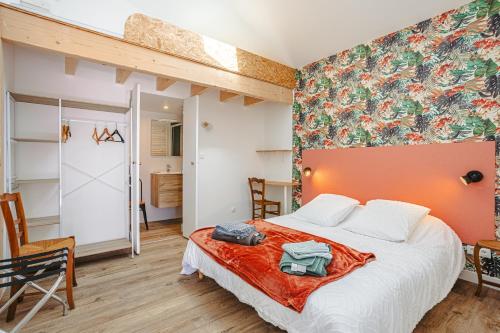 a bedroom with a large bed in a room at Gite La Grange Hulotte in Chaillé-les-Marais