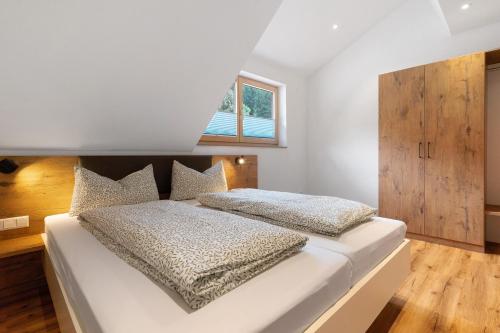 a bedroom with a large white bed and a window at Ferienwohnung Burgblick in Biberach