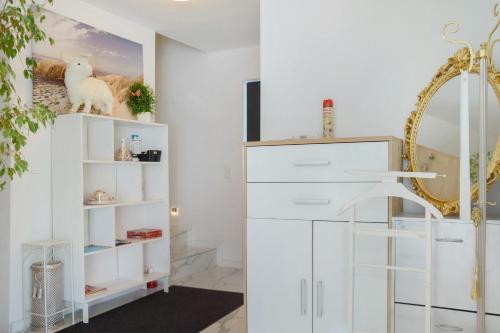 a room with white shelves and a mirror at Luxusvilla Neubau 1 in Oberasbach