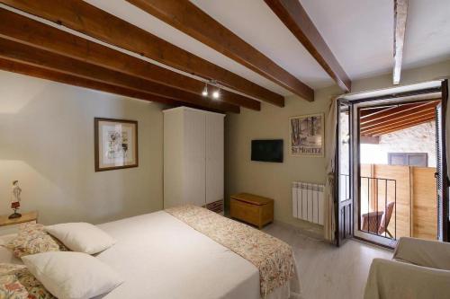 a bedroom with a bed and a large window at Can Teresa in Capdepera