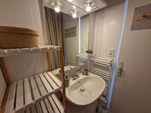 a bathroom with a sink and a mirror at L'instant Terrière,maison de charme in La Tranche-sur-Mer