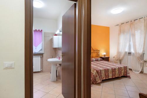 a bedroom with a bed and a sink in a room at Il Frutteto 50 in Ortovero