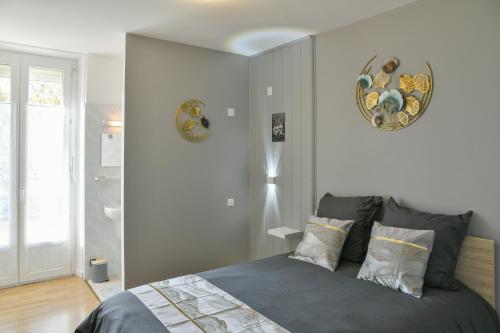 a bedroom with a bed with two pillows at Chambres d'hôtes - Chez Antho in Betton-Bettonet