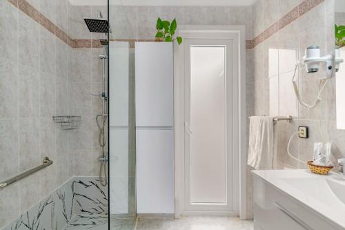 a bathroom with a shower and a glass door at Casita Isabella in El Golfo