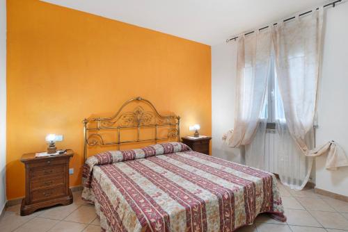 a bedroom with a large bed and a window at Il Frutteto 50 in Ortovero
