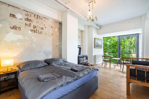 a bed in a room with a wall with writing on it at Fewo Boho in der Altstadt in Pirna