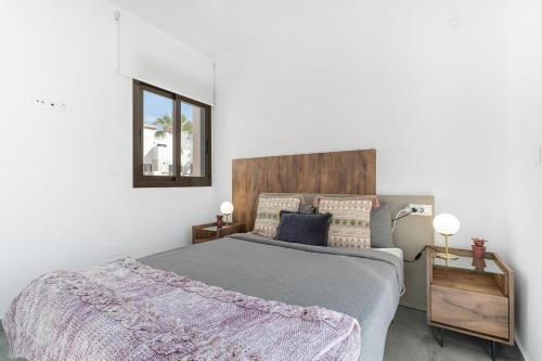 a bedroom with a large bed and a mirror at Chalet con Piscina in Orihuela Costa
