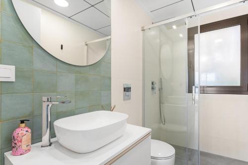 a white bathroom with a sink and a shower at Chalet con Piscina in Orihuela Costa