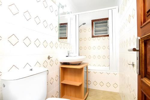 a bathroom with a toilet and a sink at Villa Barraca in Pollença