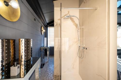 a shower with a glass door in a bathroom at Maison boutique At Pietro in San Pietro in Lama
