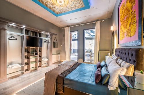 a bedroom with a large bed with a couch at Maison boutique At Pietro in San Pietro in Lama