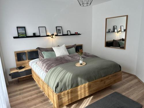 a bedroom with a large bed with a table on it at Tannenblick in Schönwald