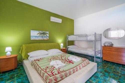 a bedroom with a bed and a bunk bed at Bes Beach - Villa con piscina in Fontane Bianche