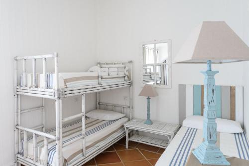 a room with two bunk beds and a lamp at Li Conchi 34 in Castiadas