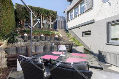 a patio with a table with a lamp on it at Ferienwohnung Riekes in Schmallenberg