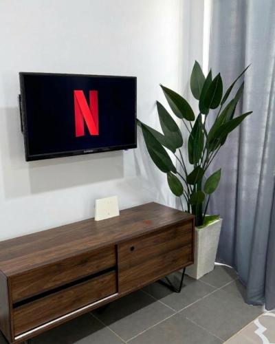 a tv with the letter n on a wall at Kanvas 21 in Jerantut