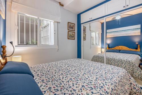 a bedroom with two beds and a window at Brisa y Mar in Calahonda
