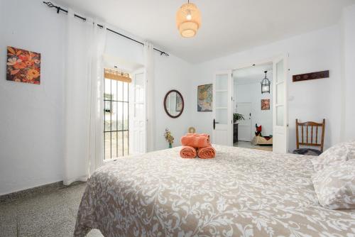 a bedroom with a bed with a stuffed animal on it at La Casa De Eva in Gaucín