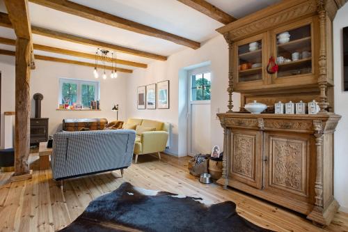a living room with a large wooden fireplace and a living room at Peene Hus in Hohen Demzin