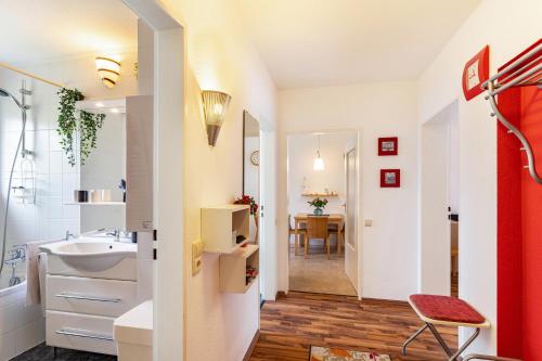 a bathroom with a sink and a toilet and a table at Ferienwohnung Am Paradies in Baden-Baden
