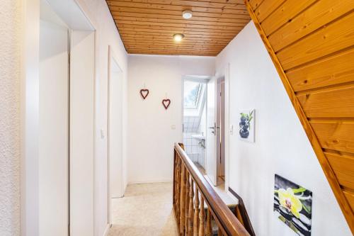 a staircase in a house with a wooden ceiling at Ferienhaus Knappstein in Möhnesee