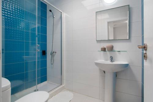 a bathroom with a shower and a sink and a toilet at Los Morros in Punta Mujeres
