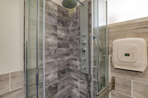 a shower stall with a soap dispenser in a bathroom at Le Cosy à la grande pyramide in La Grande Motte