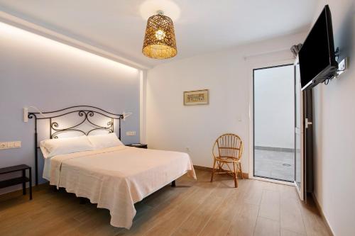 a bedroom with a bed and a large window at Falco 1 in Corralejo