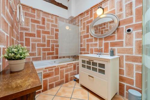 a bathroom with a brick wall at Apartamento con Encanto C in Montroig