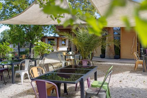a group of tables and chairs under an umbrella at Albchalet in Rosenfeld