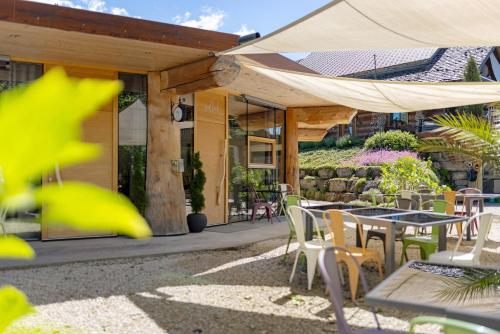 a patio with tables and chairs and a tent at Albchalet in Rosenfeld